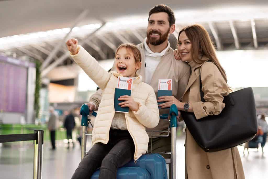Boarding happy family with tickets at airport, travel insurance, airline travel, and vacation planning.